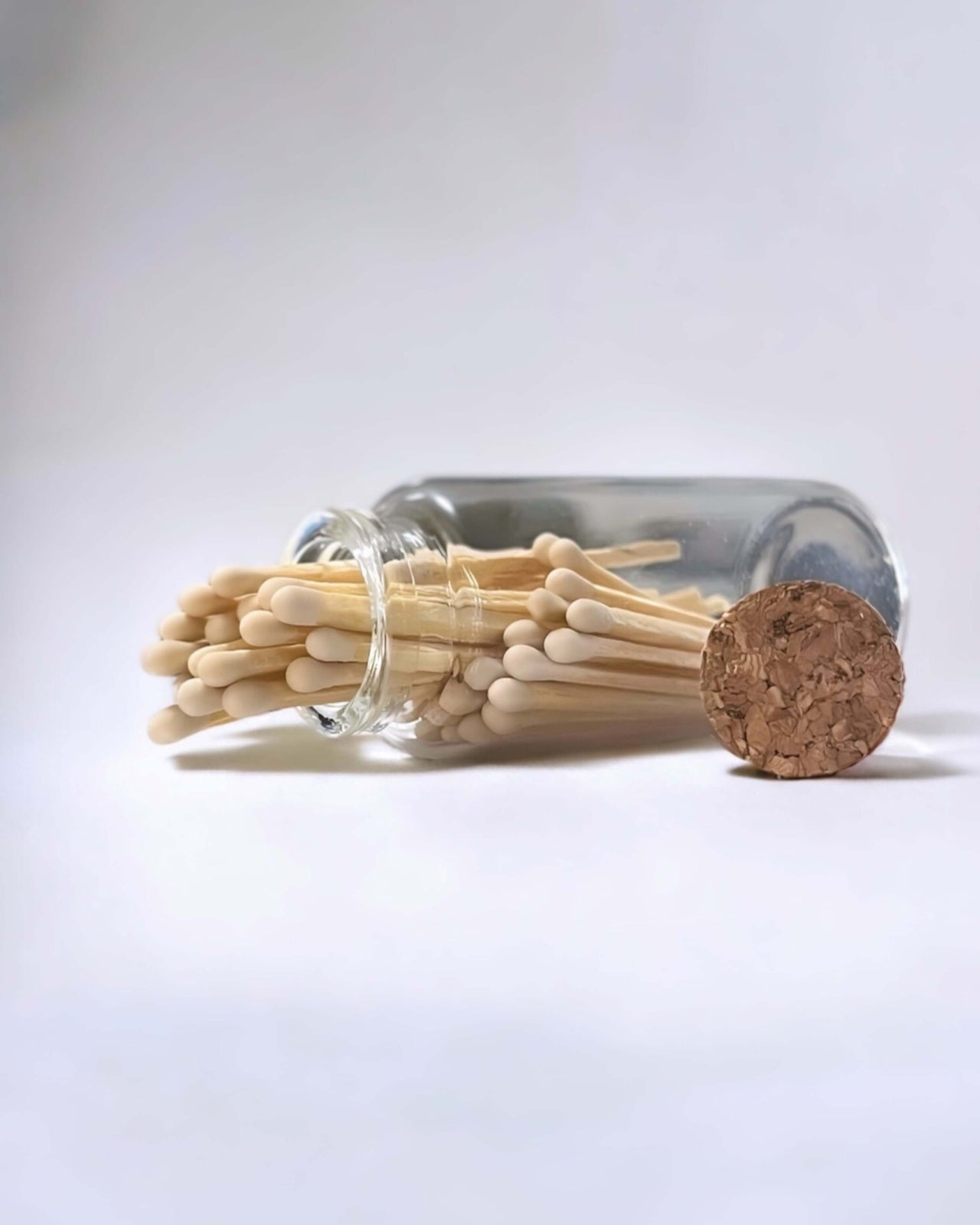 Stylish eggshell white multicoloured matches come in a mini apothecary jar