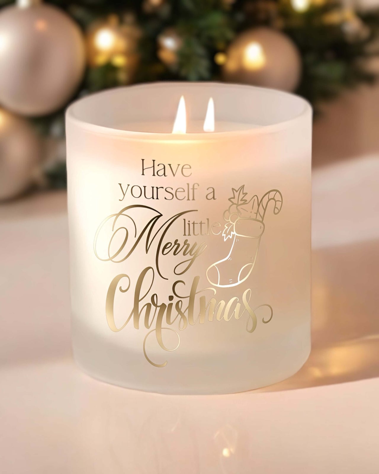 each candle features elegant gold-accented writing that reads "Have yourself a Merry little Christmas".