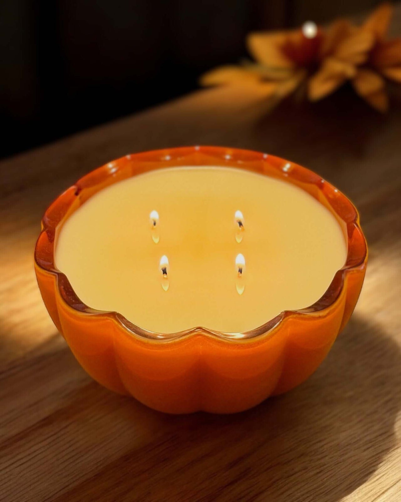 Stunning pumpkin spice candle burning brightly.