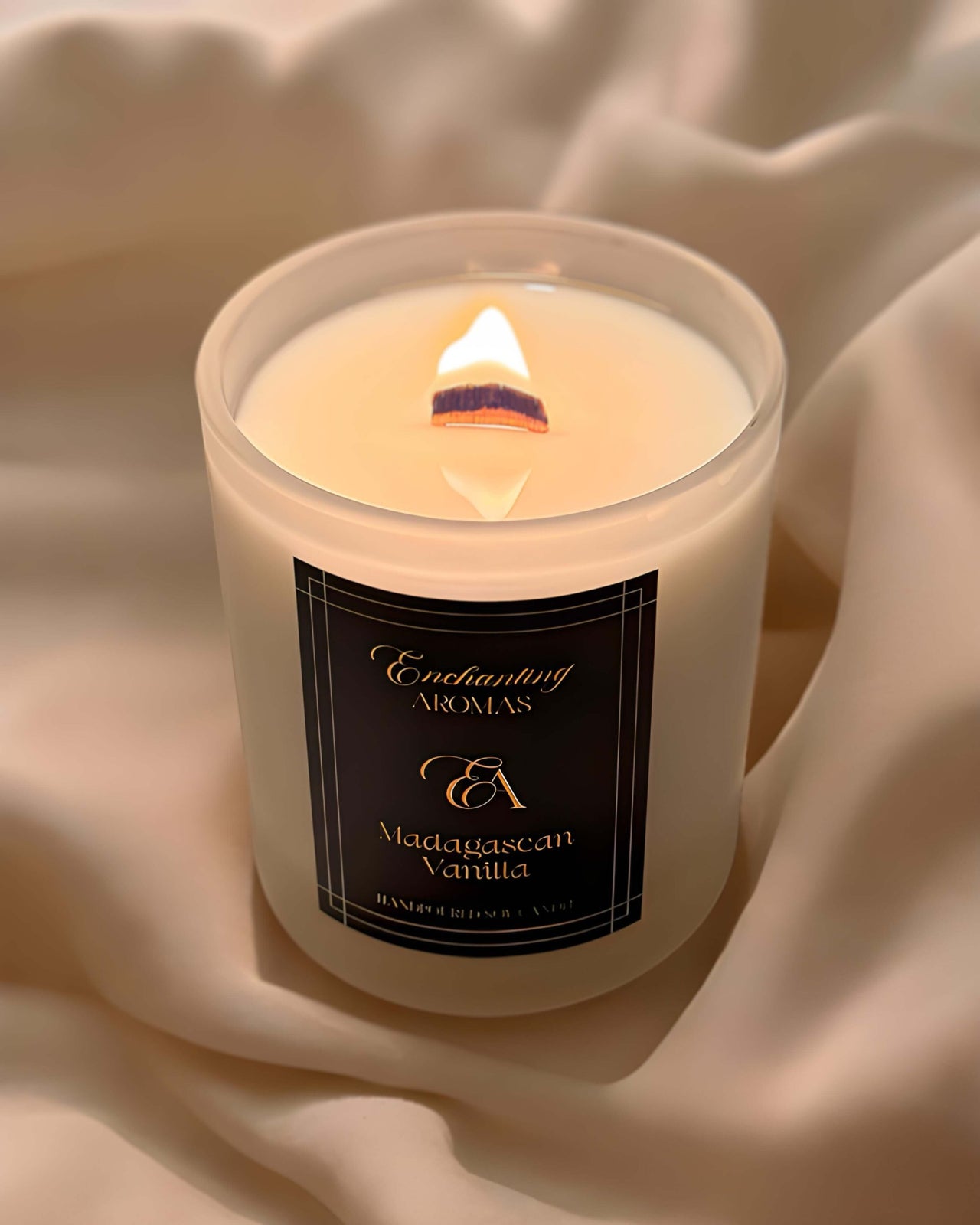 Luxe Winterwood Whisper Candles with a wooden wick burning brightly.