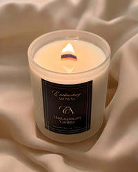 Thumbnail for Luxe Winterwood Whisper Candles with a wooden wick burning brightly.