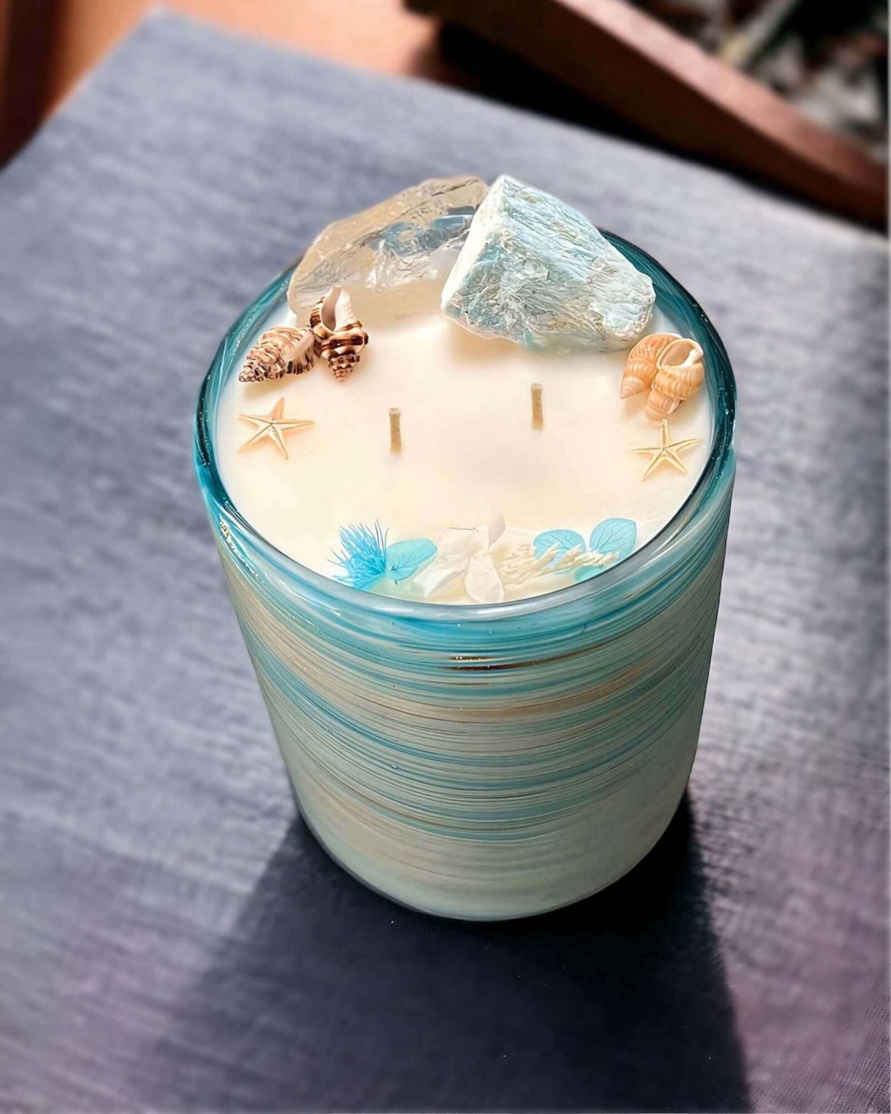 Experience luxury with the Coastal Tides Grand Luminary Candle. Over 100 hours of burn time with natural Amazonite and Clear Quartz. Perfect for elegant decor. $115.00